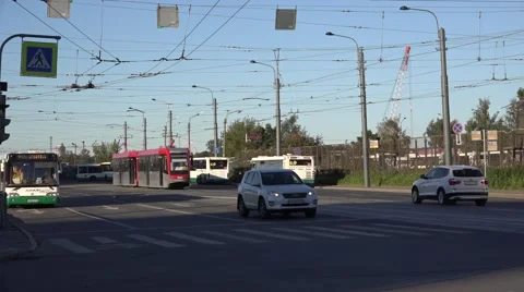 Back-to-back coupled 2-car tram heads to terminus and diesel bus leaves that Stock Footage 67576871
