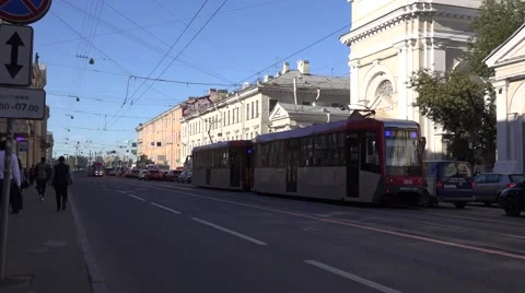Back-to-back coupled 2-car double-sided trams in traffic at temporary terminus Stock Footage 67576893