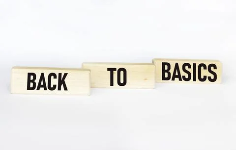 The "Back to basics" symbol. The conceptual words "Back to the roots" on a wo Stock Photos