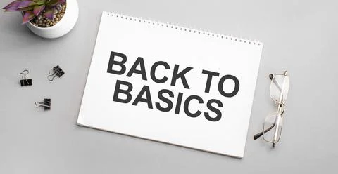 BACK TO BASICS is written in a white notebook next to a pencil, black-framed  Stock Photos