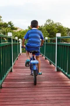 Back of the boy biking. Stock Photos