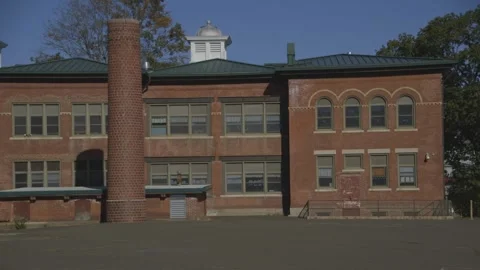 Back of brick school building, pavement courtyard Stock Footage 304373127