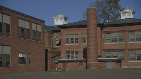 Back of brick school building, pavement courtyard Stock Footage 304373146