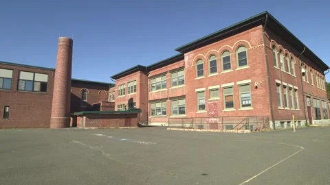 Back of brick school building, pavement courtyard Stock Footage 304373204