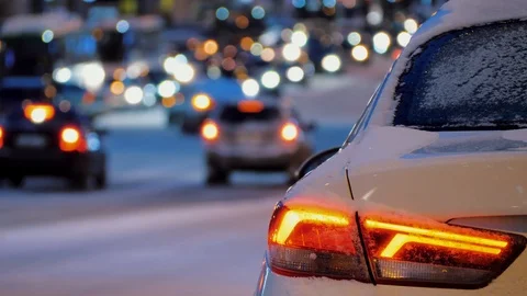 Back of car parked in background of city car traffic, car taillights are on Video stock 123856866