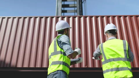 Back of cargo container workers help to control the crane lift down container Stock-Footage 146473872