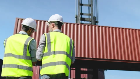 Back of Caucasian cargo container worker discuss and work together Stock Footage 146476215
