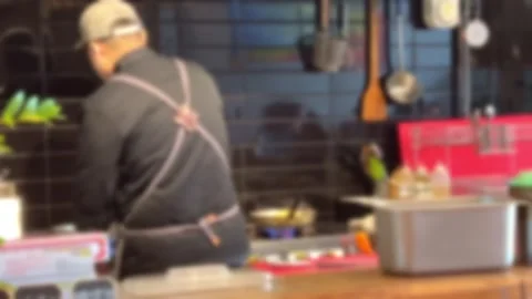 The back of a chef cooking in a restaurant Stock Footage 259304777