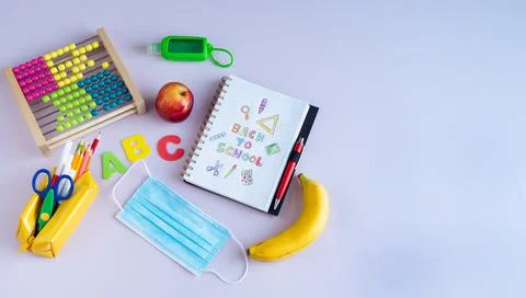 Back to class. Notebook with text and various complements. Stock Photos