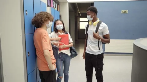 Back to class of young students wearing masks to protect themselves from the Stock Footage 160024084