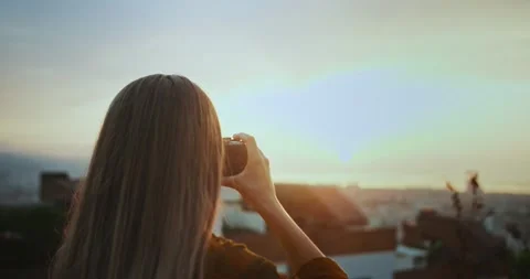 Back close up shot of charming young female using camera to make photo of urban Video stock 138811515