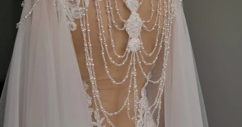 The back close-up view of the wedding dress  decorated with beads. Stock Footage 130051346