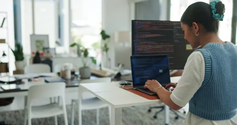 Back, computer screen and programming with business woman at standing desk in 動画素材 321113871