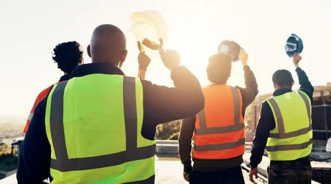 Back, construction and team celebration on site for foundation finish, insp.. Stock Photos