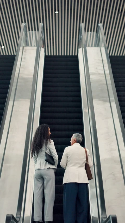 Back, conversation and escalator with business woman in airport together for Stock Footage 321451397