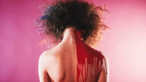 On the back of a curly model pours a paint Stock Footage 81697536