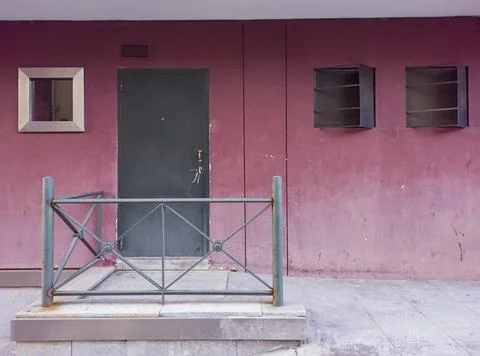 Back door of a building in a reddish wall Stock Photos