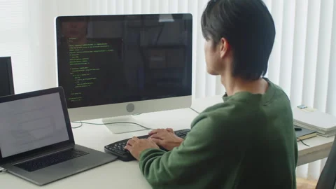 Back-end Developer Writing Code Sitting in front of Computer Stock Footage 256974167
