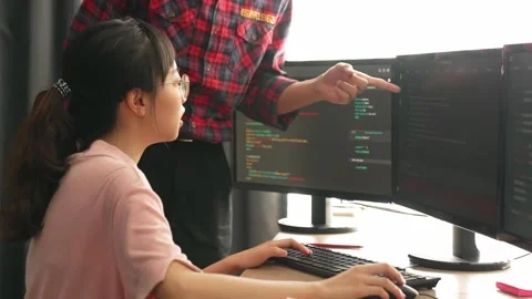 Back end or software developer manager supervising coding. Burgeoning Stock Footage 262147191