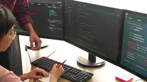 Back end or software developer manager supervising coding. Burgeoning Stock Footage 263038559