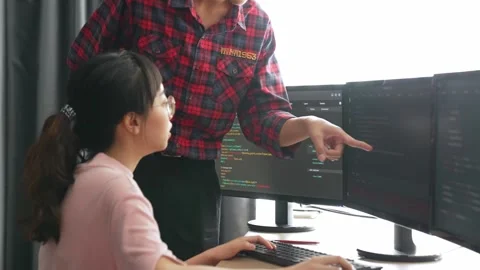 Back end or software developer manager supervising coding. Burgeoning Stock Footage 264531942
