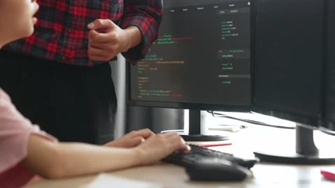 Back end or software developer manager supervising coding. Burgeoning Stock Footage 264635470