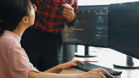 Back end or software developer manager supervising coding. Burgeoning Stock Footage 265703277