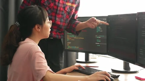 Back end or software developer manager supervising coding. Burgeoning Stock Footage 266453359
