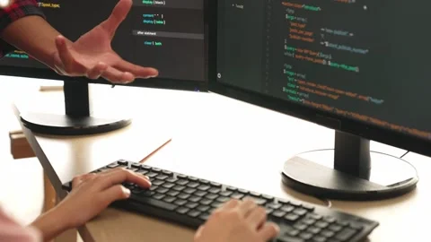 Back end or software developer manager supervising coding. Burgeoning Stock Footage 267038420