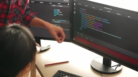 Back end or software developer manager supervising coding. Burgeoning Stock Footage 267612888