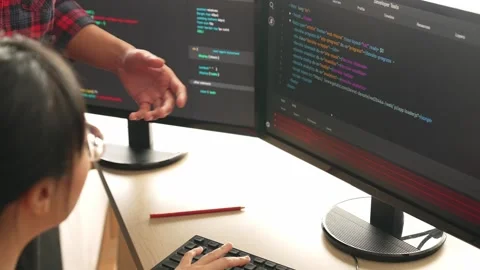 Back end or software developer manager supervising coding. Burgeoning Stock Footage 269060629