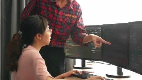 Back end or software developer manager supervising coding. Burgeoning Stock Footage 270040389