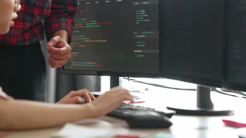 Back end or software developer manager supervising coding. Burgeoning Stock Footage 271200374
