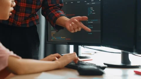 Back end or software developer manager supervising coding. Burgeoning Stock Footage 272254407