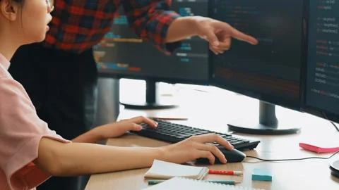 Back end or software developer manager supervising coding. Burgeoning Stock Footage 273196516