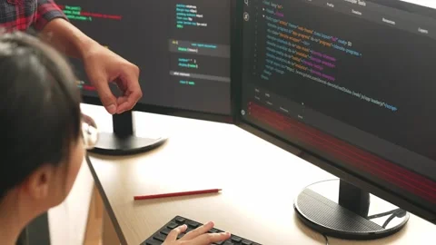 Back end or software developer manager supervising coding. Burgeoning Stock Footage 274226670
