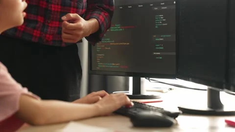 Back end or software developer manager supervising coding. Burgeoning Stock Footage 274331182