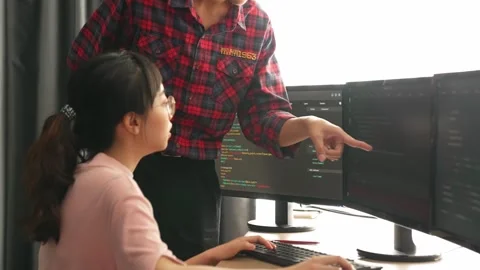 Back end or software developer manager supervising coding. Burgeoning Stock Footage 274385840