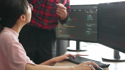 Back end or software developer manager supervising coding. Burgeoning Stock Footage 274870353
