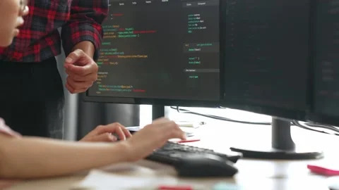 Back end or software developer manager supervising coding. Burgeoning Stock Footage 275415631