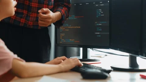Back end or software developer manager supervising coding. Burgeoning Stock Footage 279594022