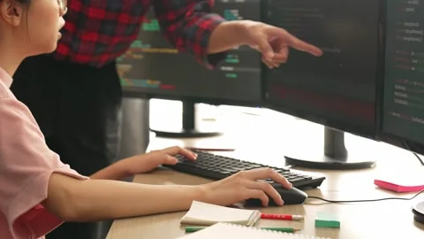 Back end or software developer manager supervising coding. Burgeoning Stock Footage 280934907