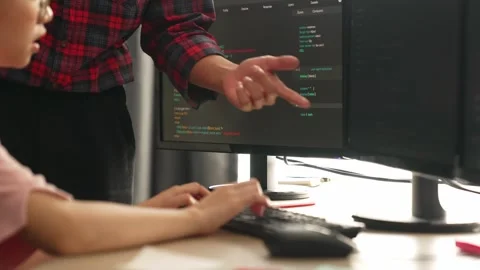 Back end or software developer manager supervising coding. Burgeoning Stock Footage 282563458