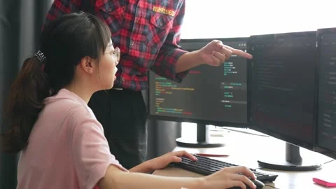 Back end or software developer manager supervising coding. Burgeoning Stock Footage 283931217