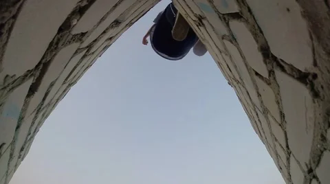 Back flip - A free runner back flips off a wall Stock Footage 67315583