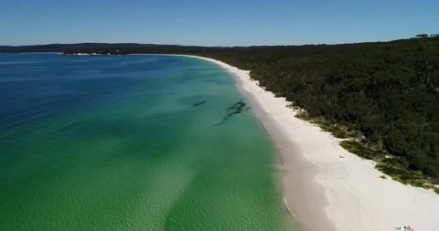 Back flying over white sandy beach of Hyams beach town in Jervis bay as 4k. Stock Footage 138928476