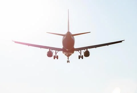 Back of flying Plane in the sky Stock Photos