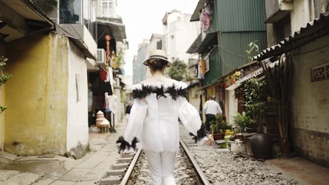 Back follow view to the beautiful and young fashion girl walking along the asian Stock Footage 114796142
