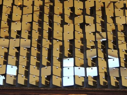 Back with gold plastic squares on threads Stock Photos