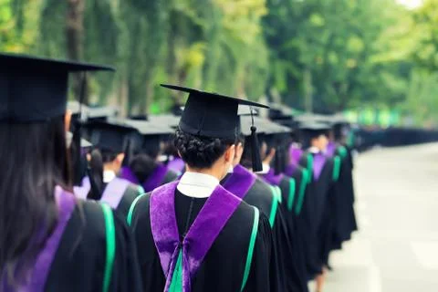 Back of graduates during commencement at university. Close up at graduate cap Stock Photos